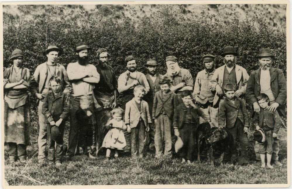 A group of 10 men, 8 children, 1 dog.