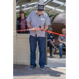 Pete Sparrow cutting the ribbon at the unveiling of the Platypus Submarine
