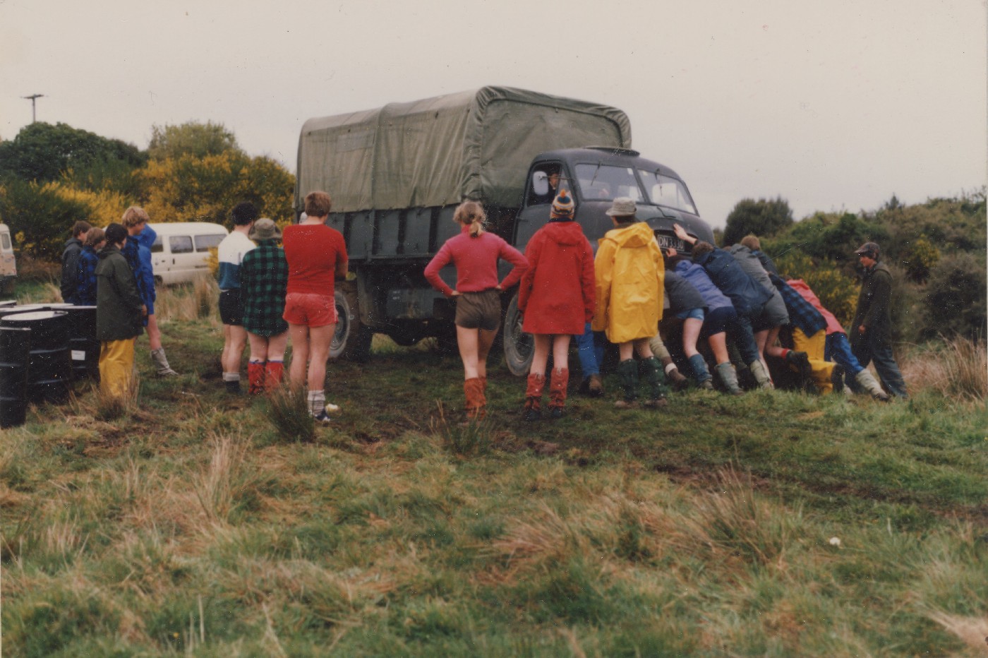 Volunteers attempt to push the stuck truck